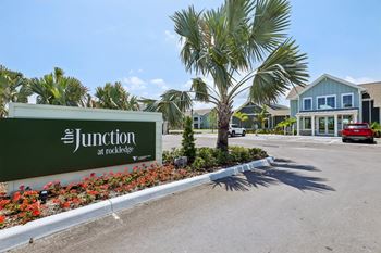 The Junction at Rockledge sign in front of a building at The Junction at Rockledge Apartments, Rockledge